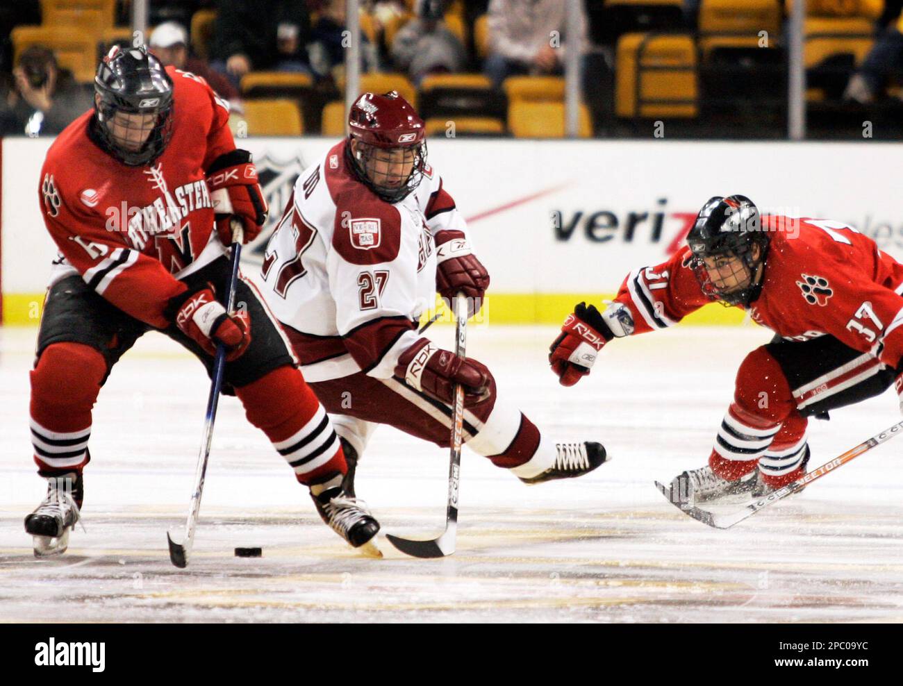 Northeastern's Kyle Kraemer (16) and Rob Rassey (37) control the puck ...