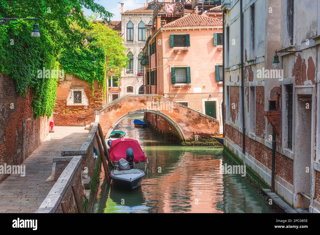 Venice, Italy. Beautiful view on Venetian canal with old colorful buildings and bridge over channel in Venezia, Veneto, Italia Stock Photo