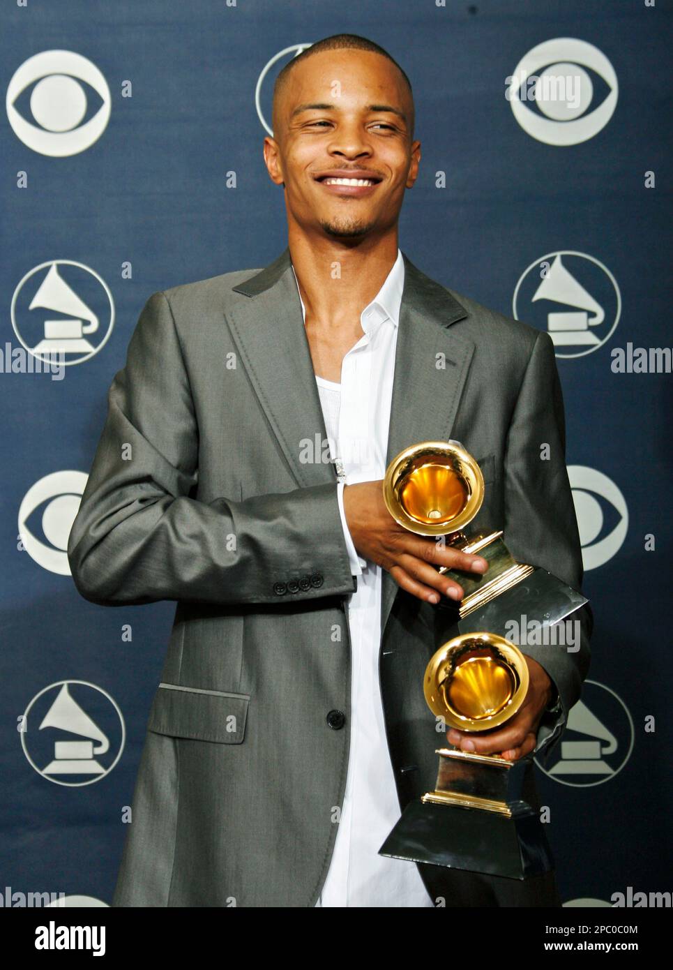 T.I. poses with the awards for best rap solo performance and for