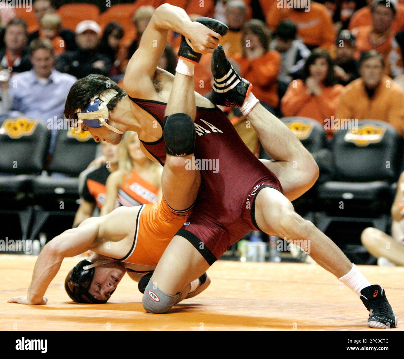 Oklahoma's Matt Storniolo, right, controls Oklahoma State's B.J