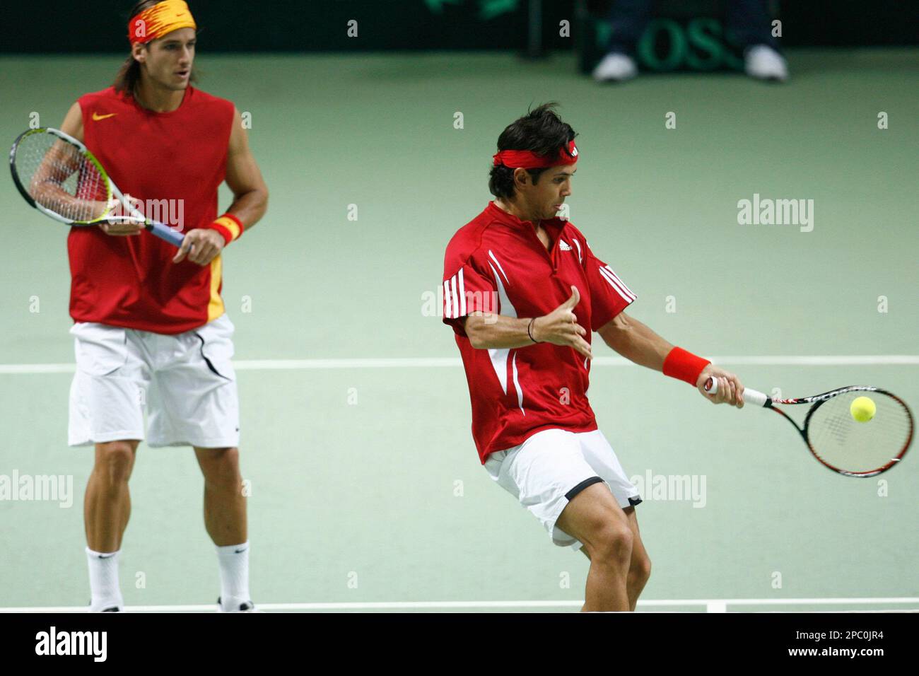 Spain's Fernando Verdasco, right, returns a ball in front teammate  Feliciano Lopez, left, during the double match against Switzerland's tennis  player Yves Allegro and teammate Marco Chiudinelli, during the Davis Cup  World