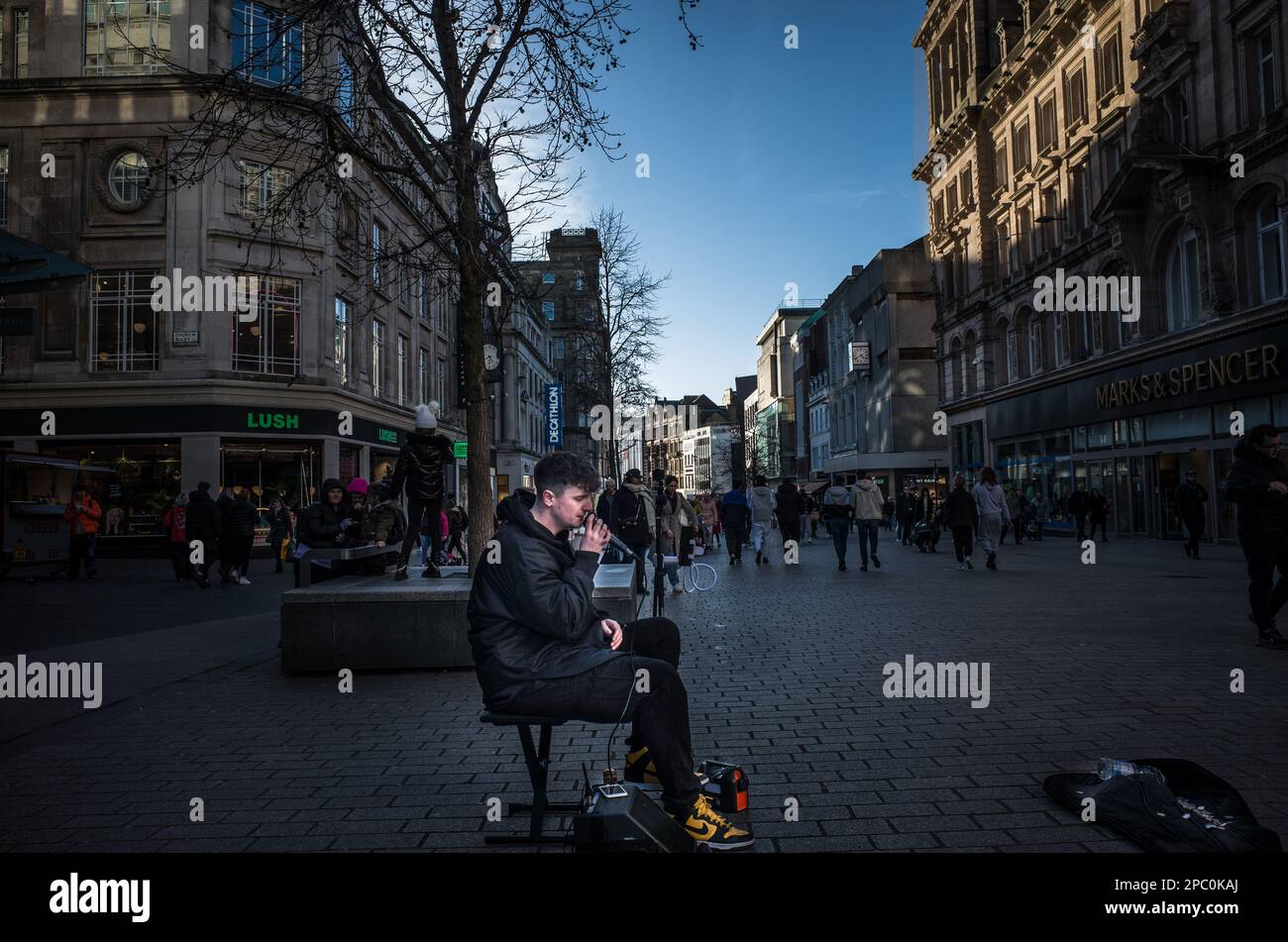3rd March  2024 -   A young man in Liverpool city centre entertains passing shoppers singing to a backing track. Stock Photo