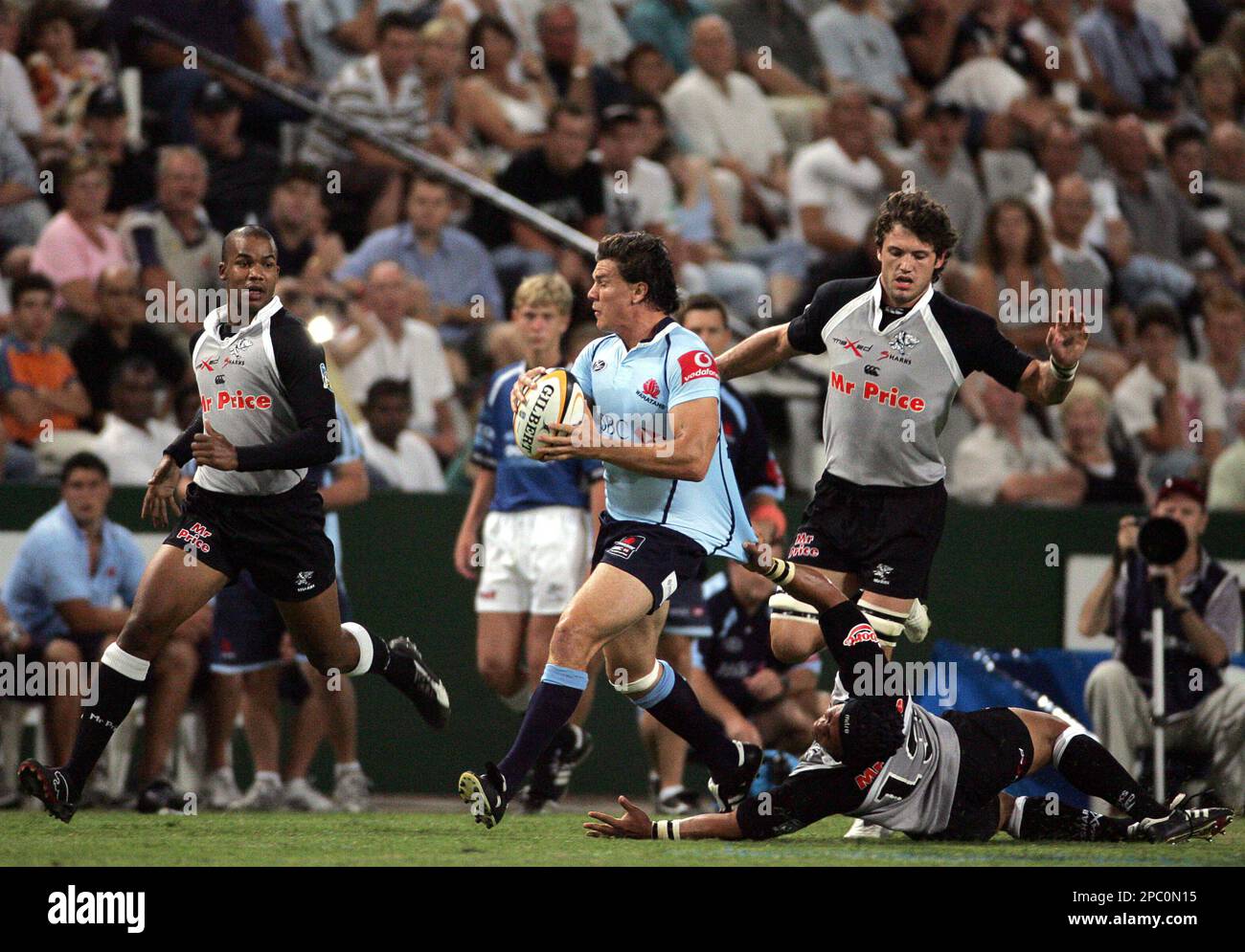 South Africa's Sharks Adrian Jacobs, on the ground, pulls down ...