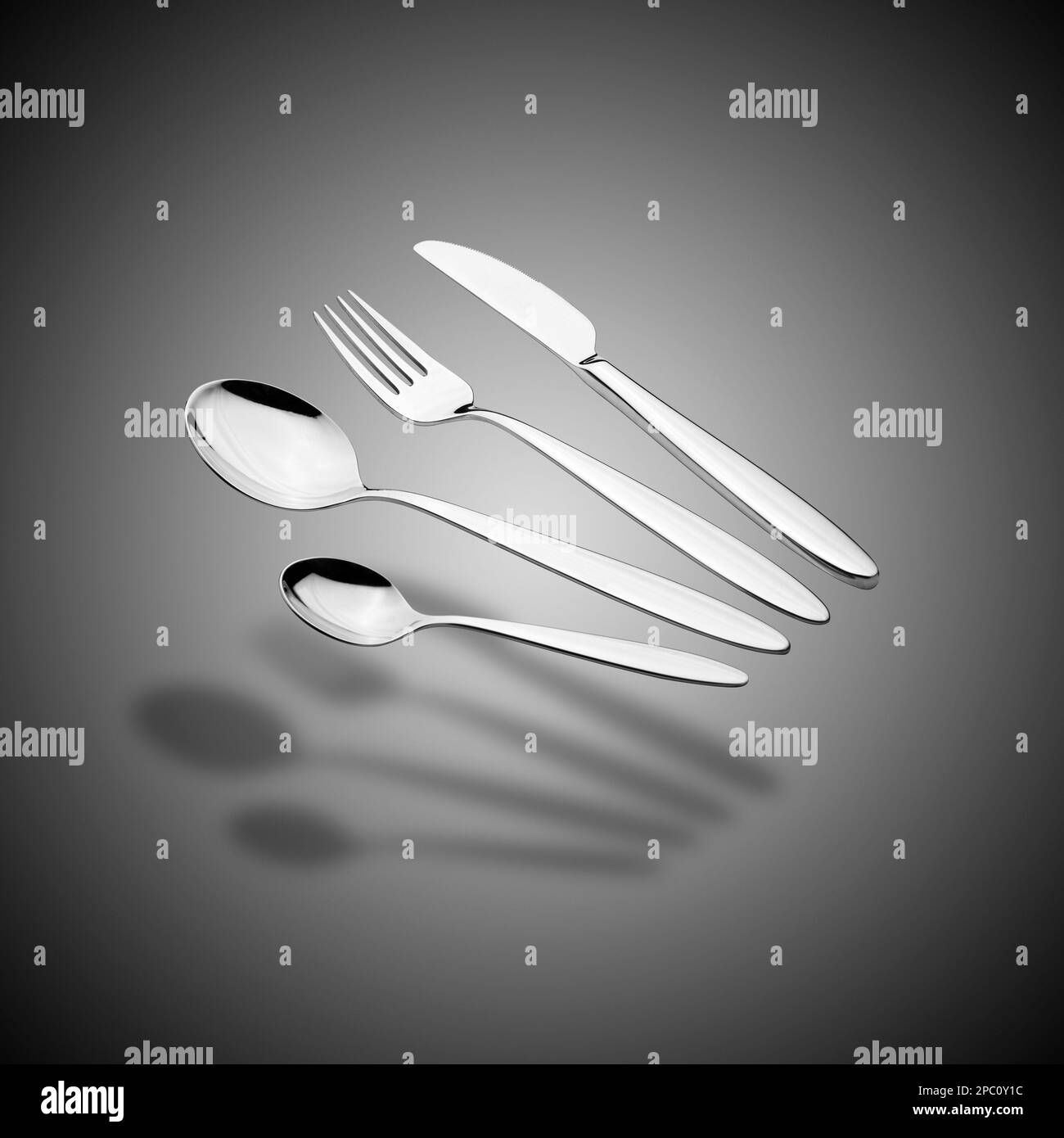 Floating Silverware Set with Fork, Knife, and Spoons on grey gradient background Stock Photo Alamy