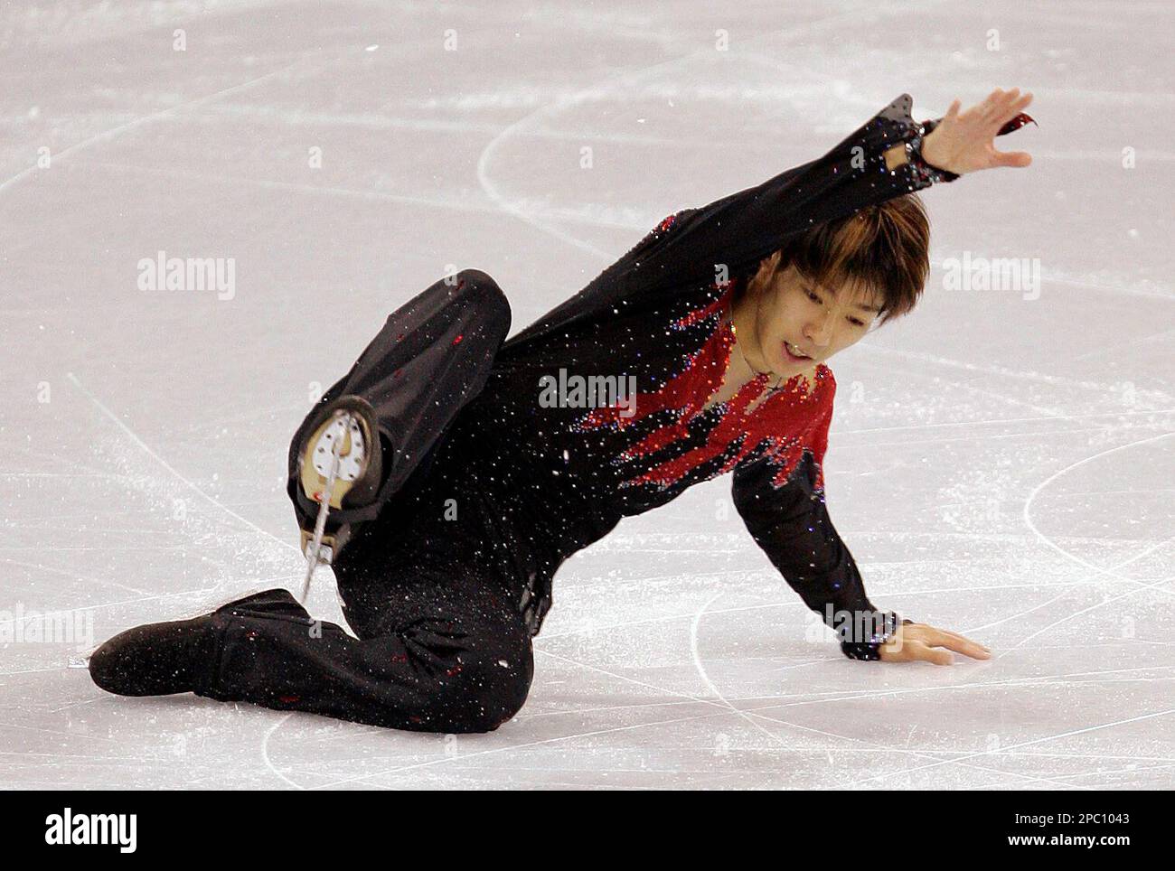 Kensuke Nakaniwa, of Japan, takes a tumble as he skates in