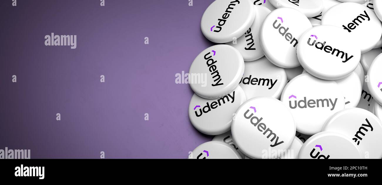 Logos of Udemy the online learning and teaching platform and company on a heap on a table. Copy space. Web banner format. Stock Photo
