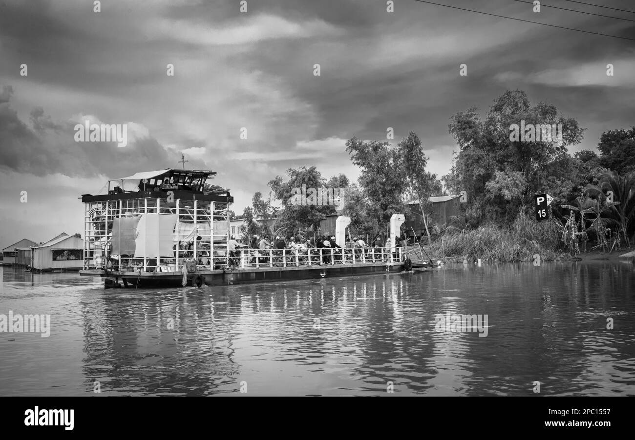 A local ferry crosses a tributary of the Mekong River in the Mekong ...