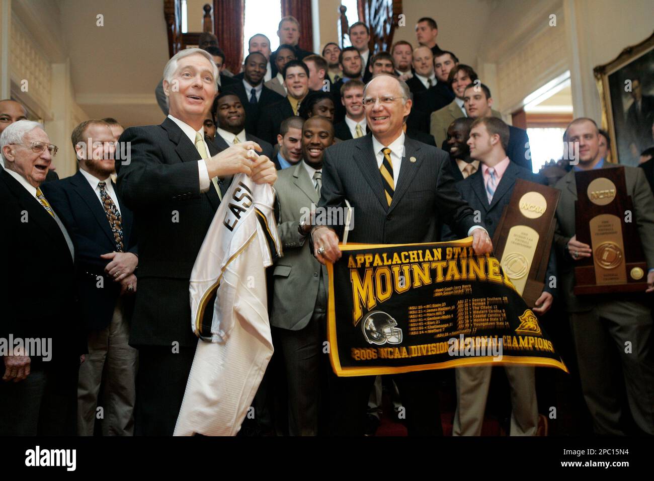 Gov. Mike Easley, left, is presented with a jersey and a banner