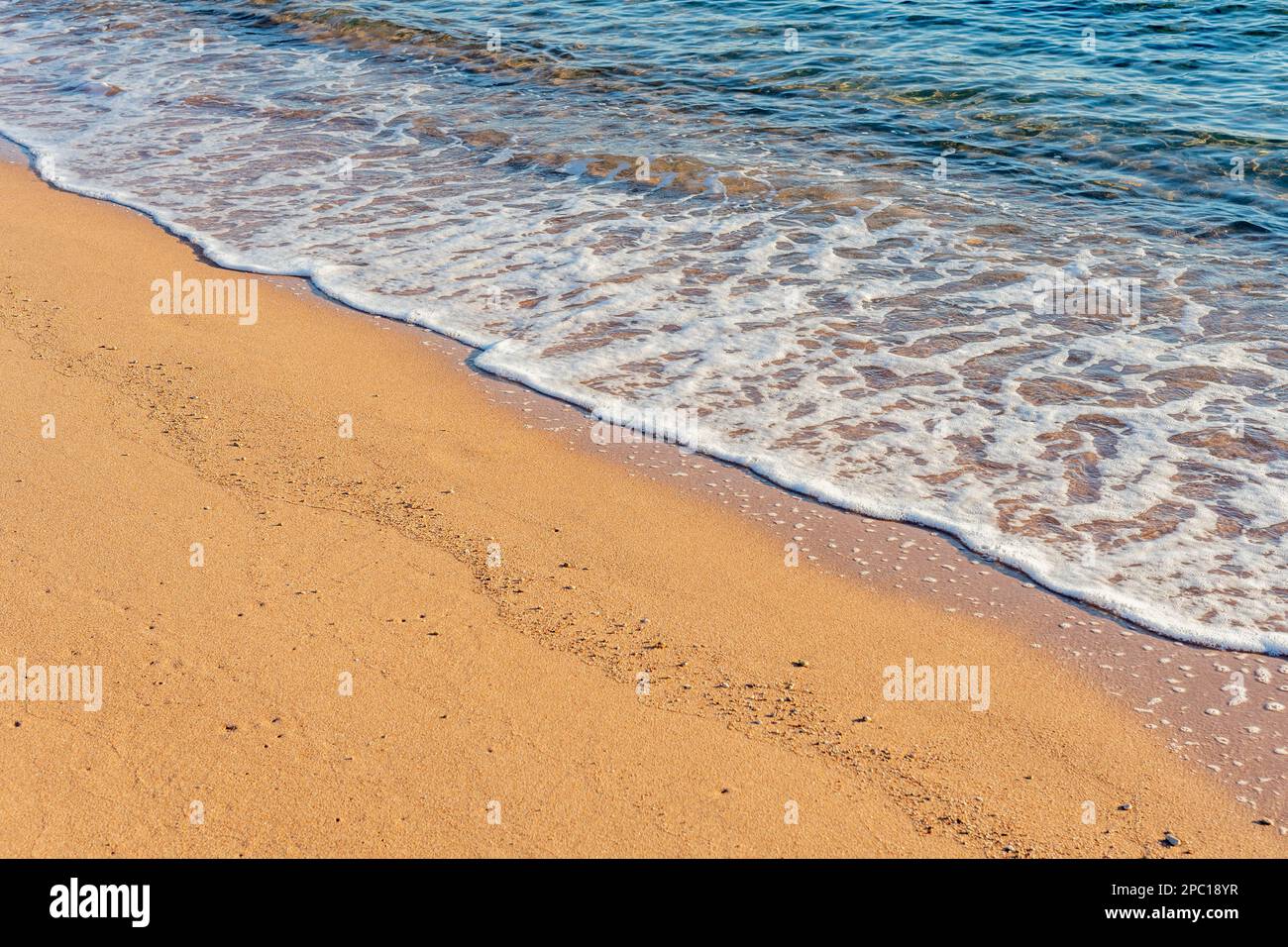 Wave of the sea with foam on the sand beach Stock Photo - Alamy