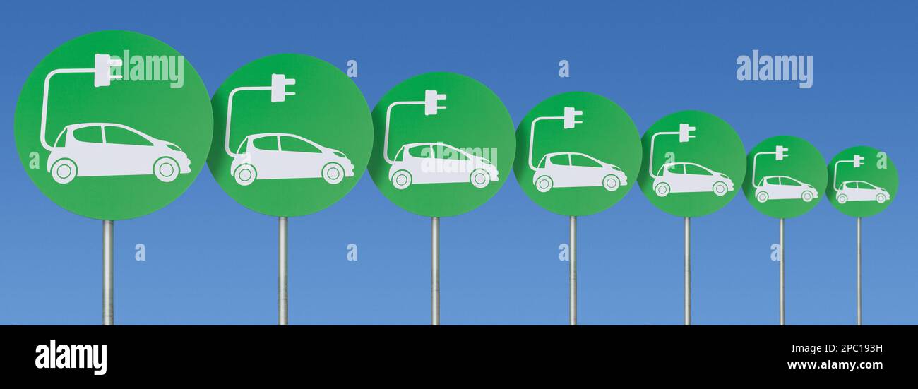 A line of green electric car plug-in signs against a bright blue sky Stock Photo