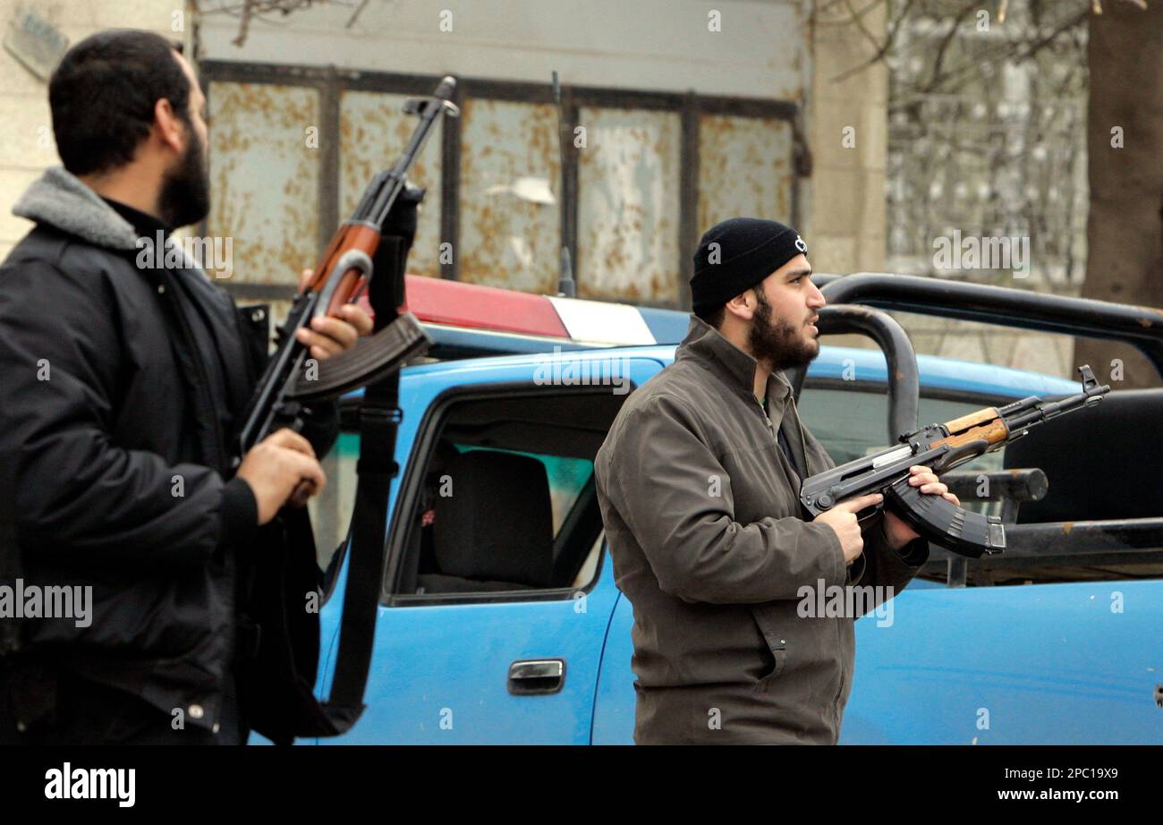 Palestinian Hamas security men stand guard next to the ministry office ...