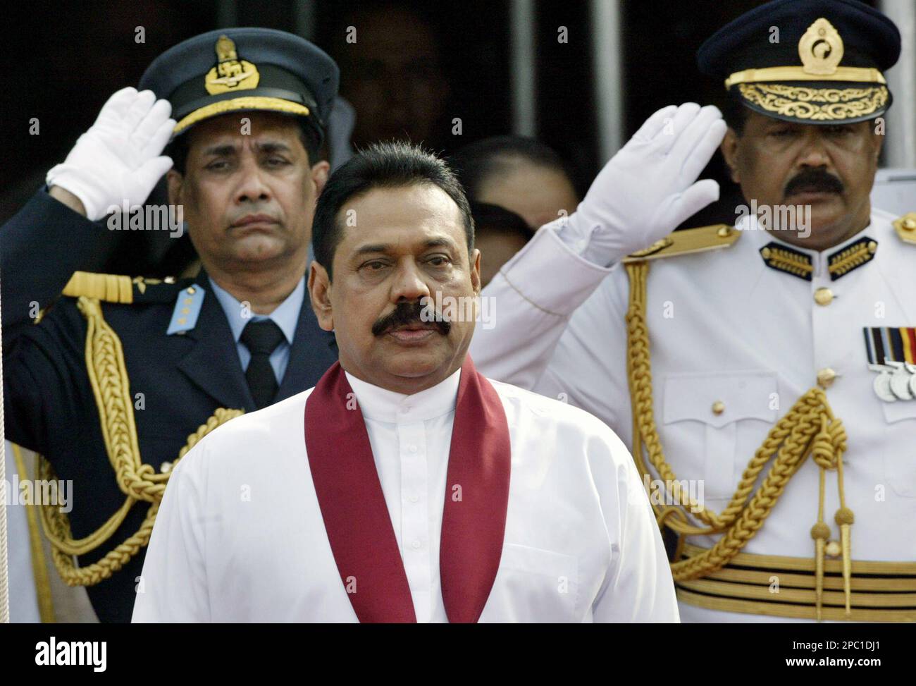 Sri Lankan President Mahinda Rajapakse, front, sings the national ...