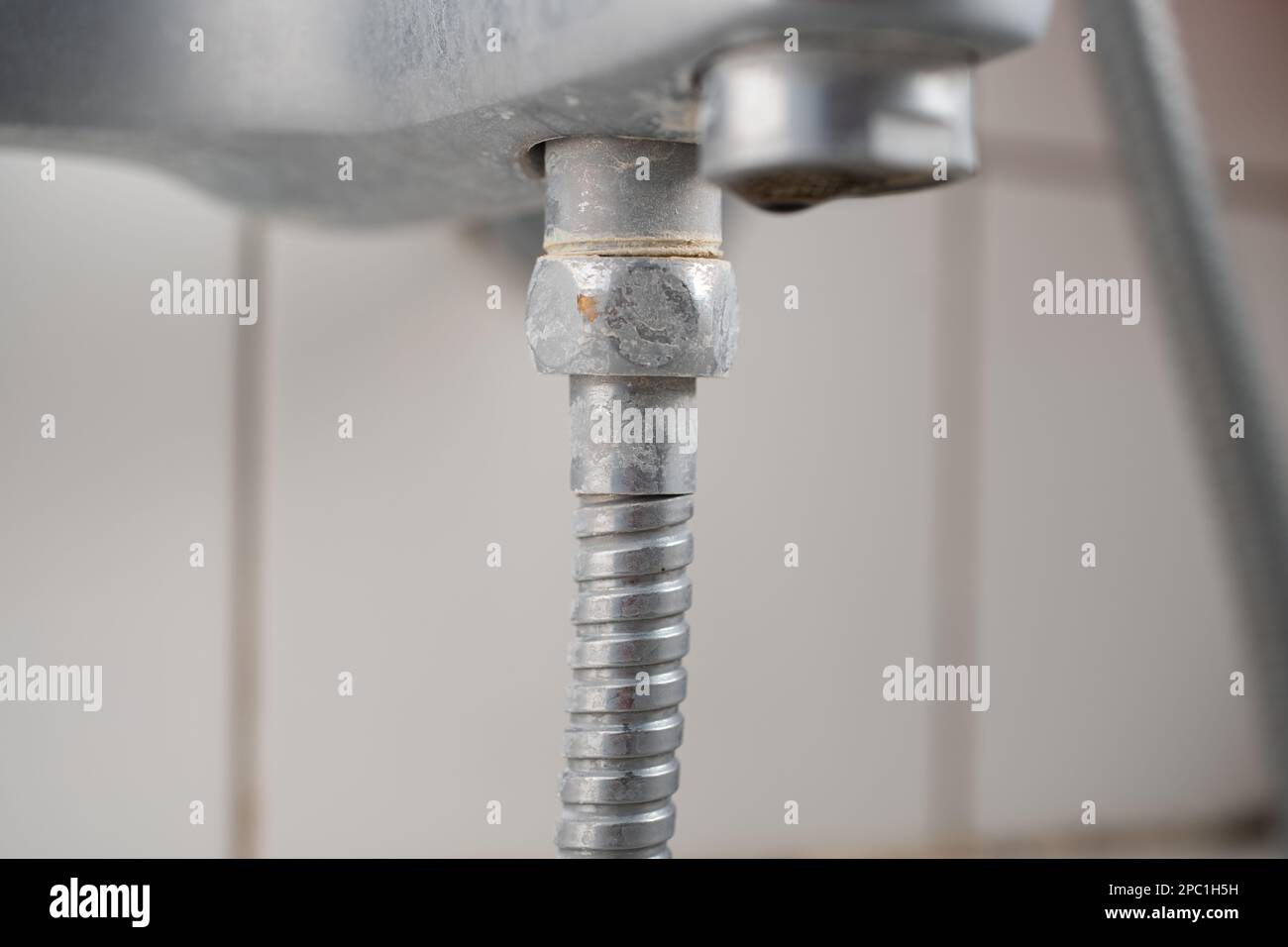 Old lime scale or calcium stained bathtub faucet from hard water. Close