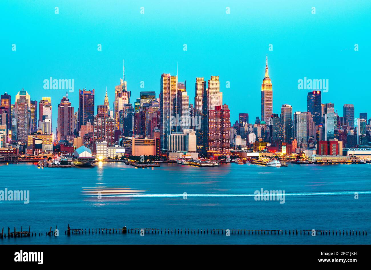 New York, New York, USA midtown skyline at dusk from the Hudson River ...