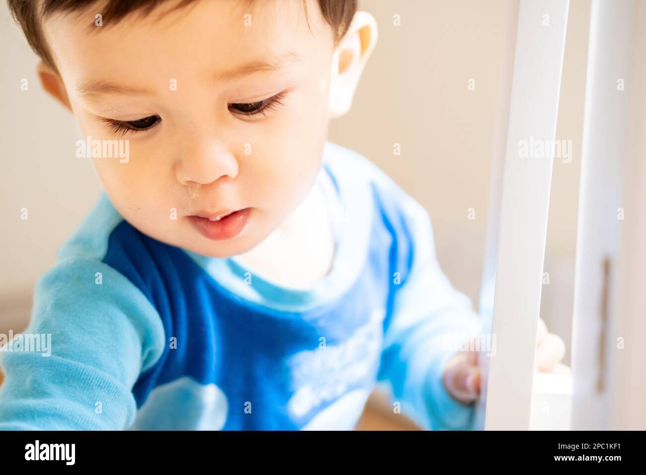 Closeup photo of an ill male infant or baby with snot or mucus under