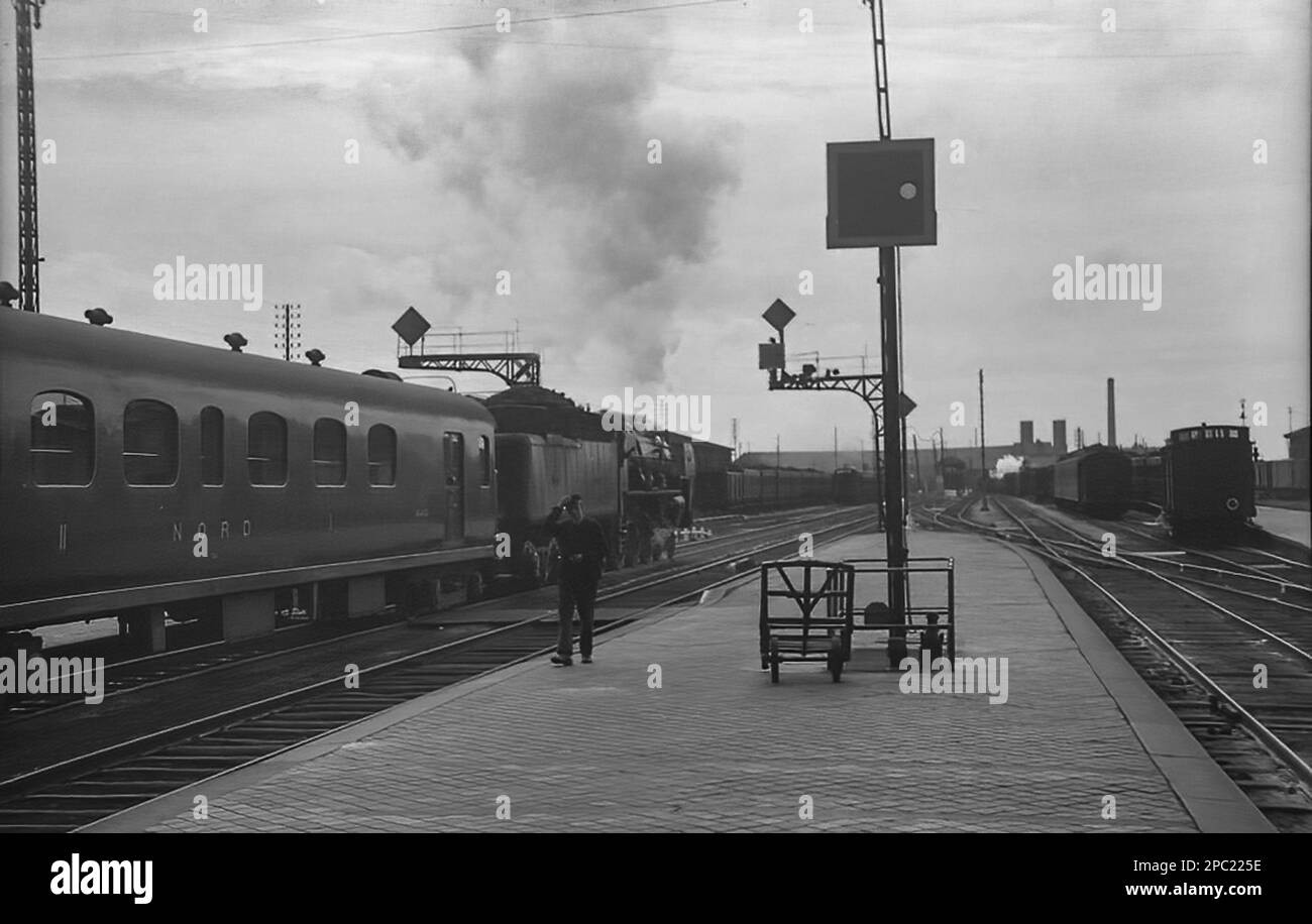 A French Nord Railway 4-6-2 Pacific steam locomotive departs from Calais with a passenger train Stock Photo