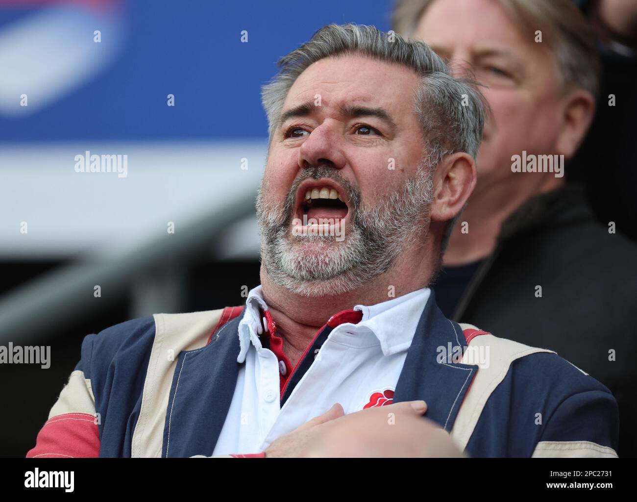 English  fan singing the National Anthem during the 2023 Six Nations Championship Round Four match between England and France at Twickenham Stadium in Stock Photo