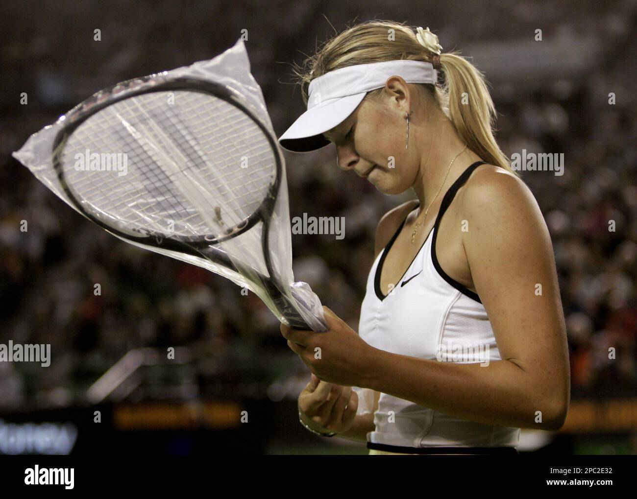 Maria Sharapova of Russia holds a new racket during her women's singles  final match against Serena Williams of the U.S. at the Australian Open  tennis tournament in Melbourne, Australia, Saturday, Jan. 27,