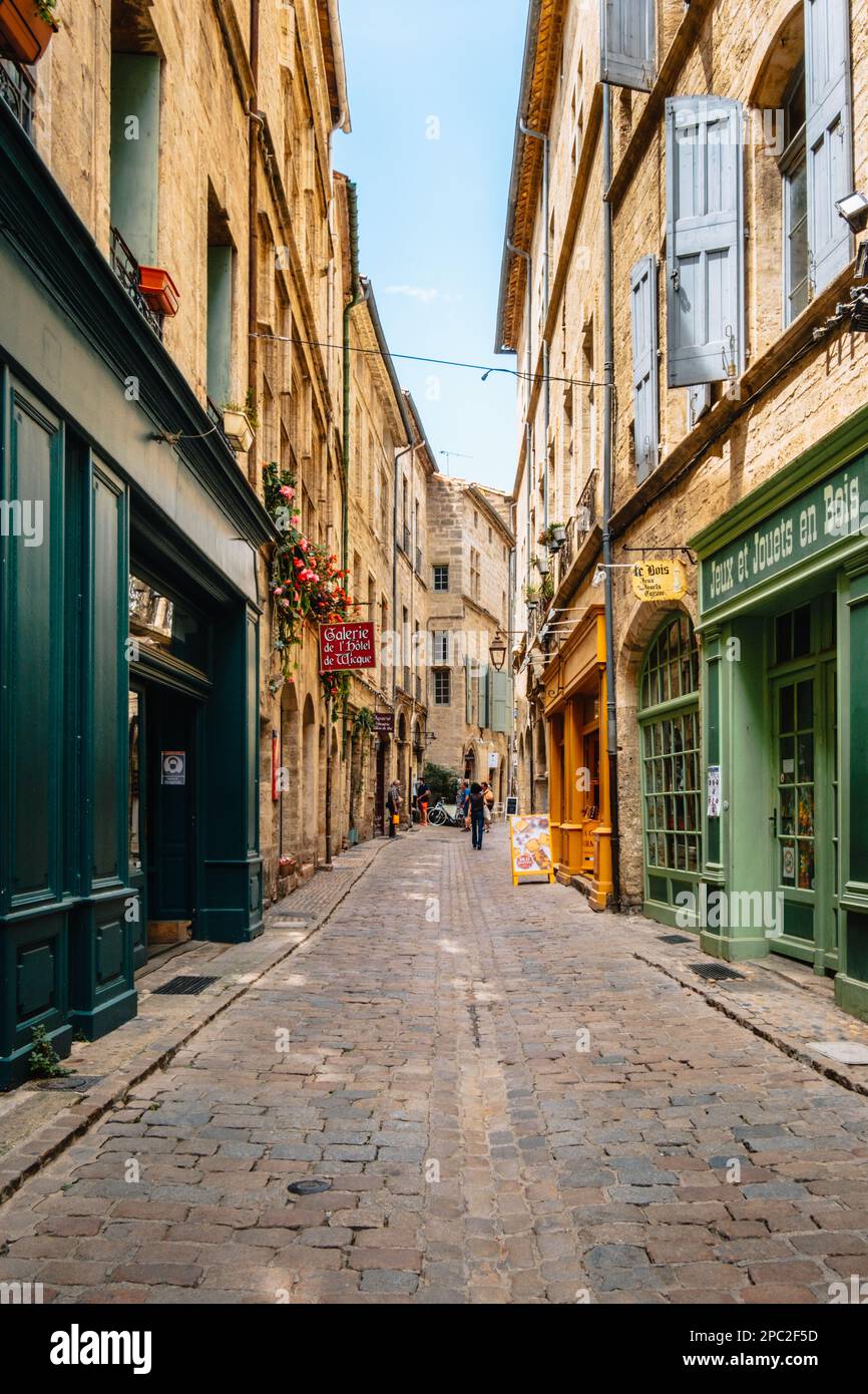 Quaint shops and facade on the cobblestone paved street of Rue de la