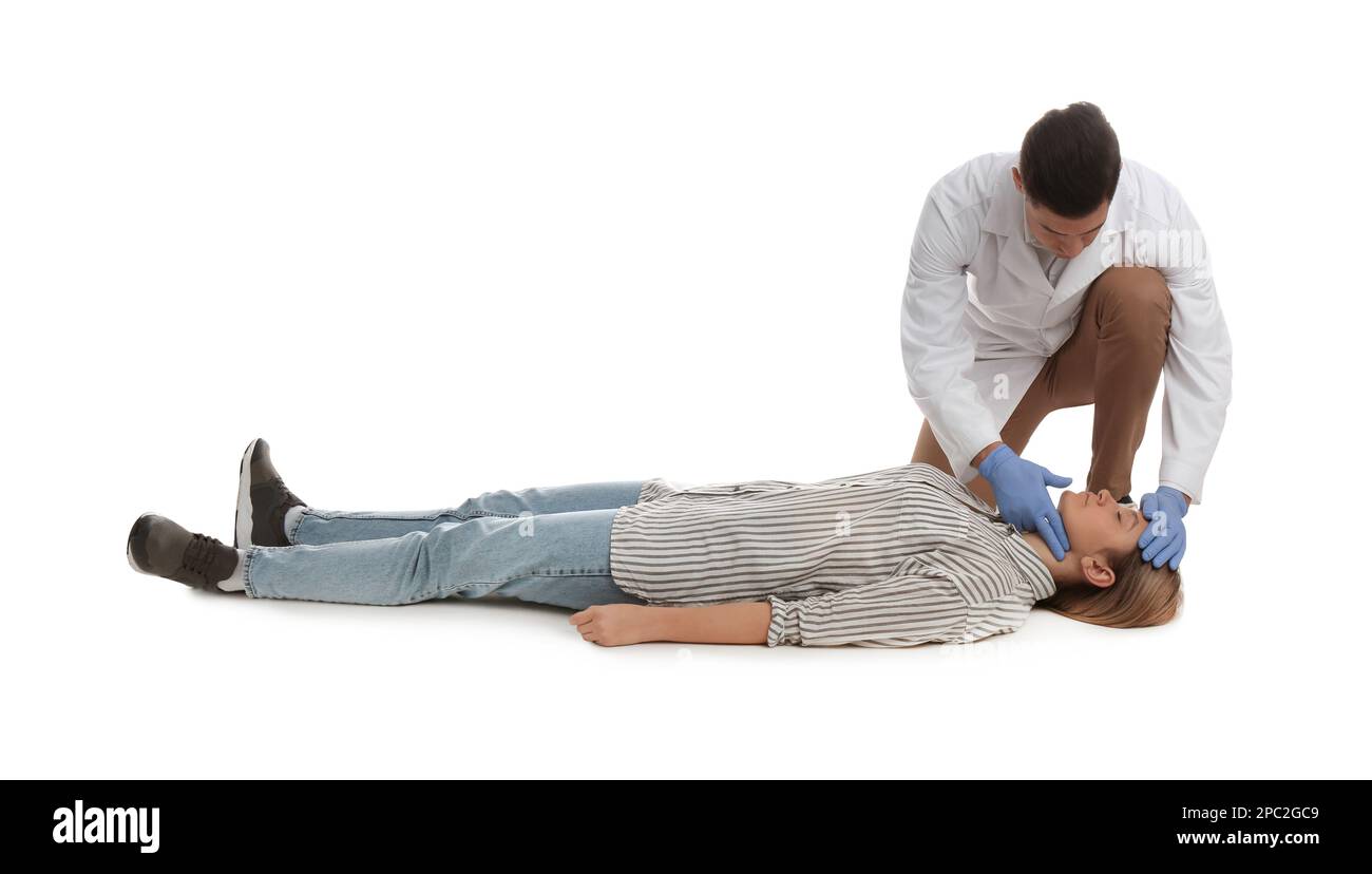 Doctor in uniform practicing first aid on woman against white ...