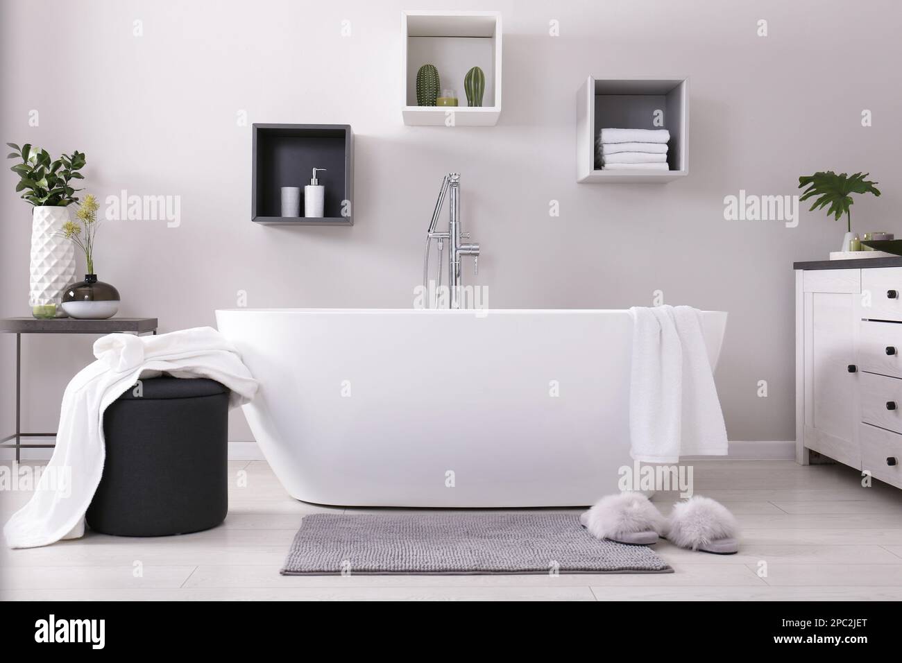 Stylish bathroom interior with modern white tub Stock Photo - Alamy