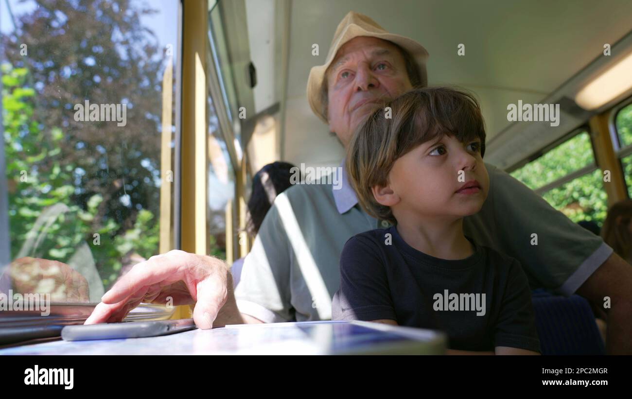 Grandparent traveling by train with grandchild. Two different ...