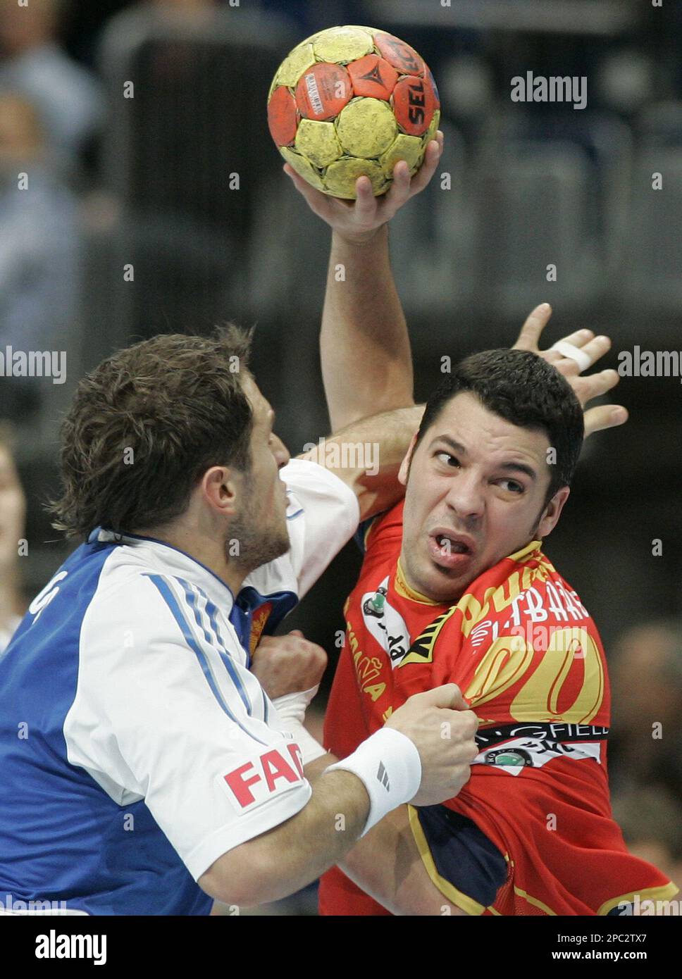 Spains Jose Maria Vaquero, right, and Russias Konstantin Igropulo fight for the ball during a Handball World Championhip main round Group M2 match between Spain and Russia in the SAP Arena in