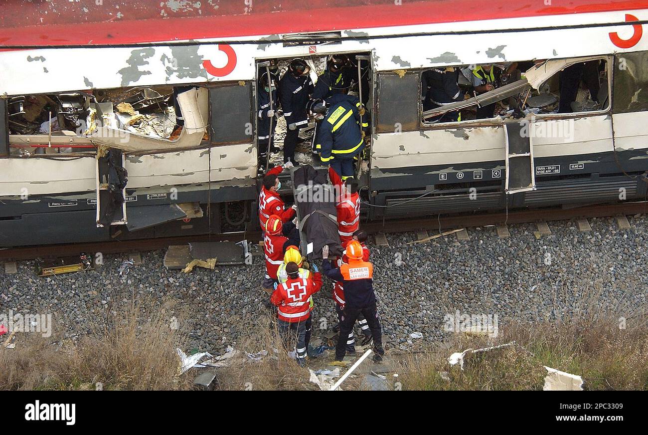 ** FILE ** Rescue workers remove a victim from a train at Atocha train station after explosions rocked three stations in Madrid in this March 11, 2004, file photo. The trial of the Madrid train bombings that killed 191 people in Spain's worst terrorist attack will begin Feb. 15 in Madrid. Twenty nine suspects, most of them Moroccan nationals, will take the stand in Spain as the result of Spanish Judge Juan del Olmo's nearly two-year investigations.(AP Photo/Peter Dejong, File) Stock Photo