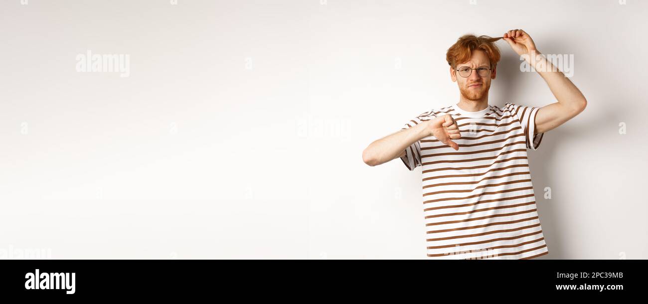 young-redhead-man-showing-his-messy-haircut-and-thumbs-down-need