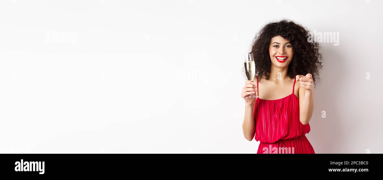 Beautiful curly woman in red dress, partying or having romantic date