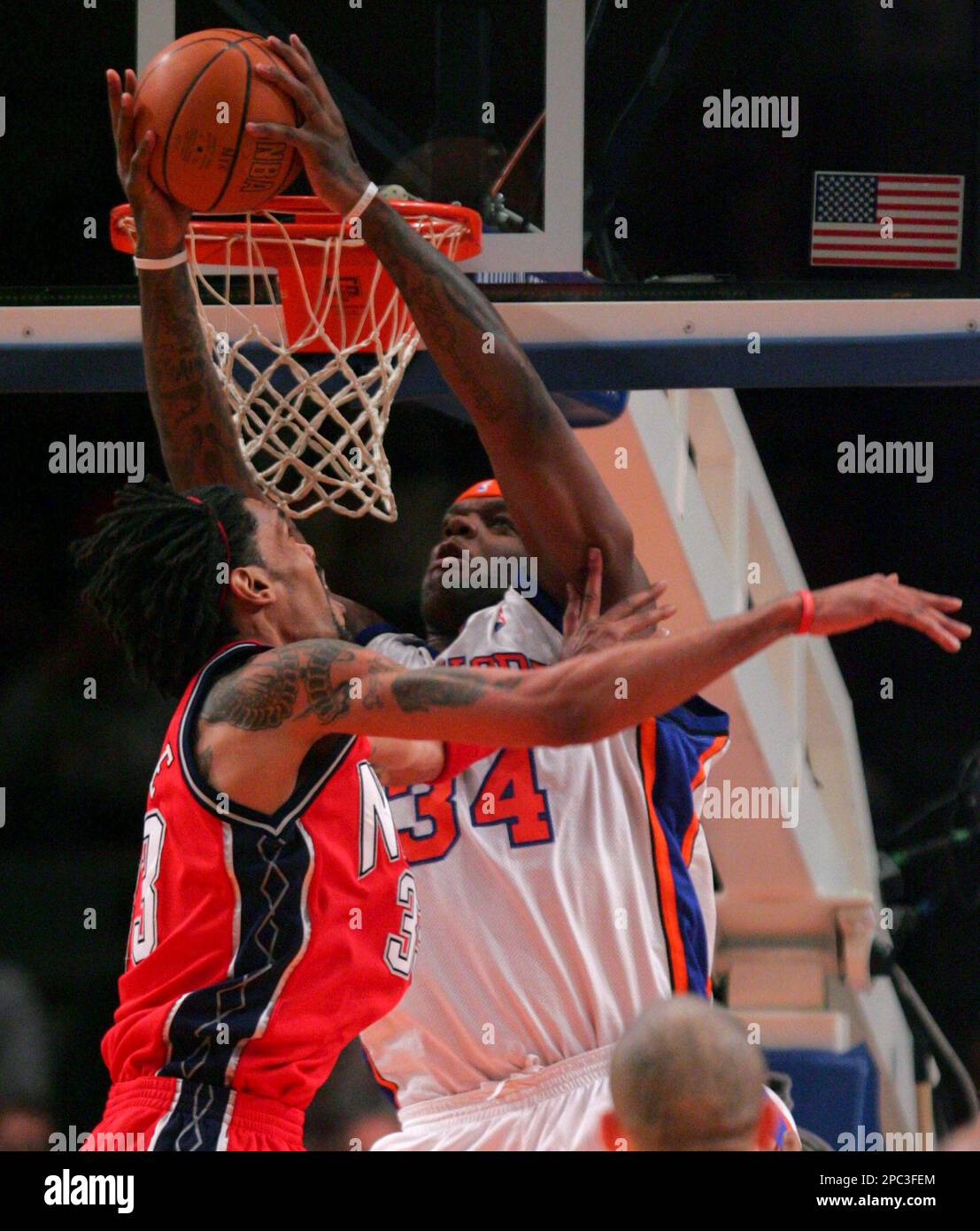 New York Knicks' Eddy Curry makes a reverse-dunk on New Jersey