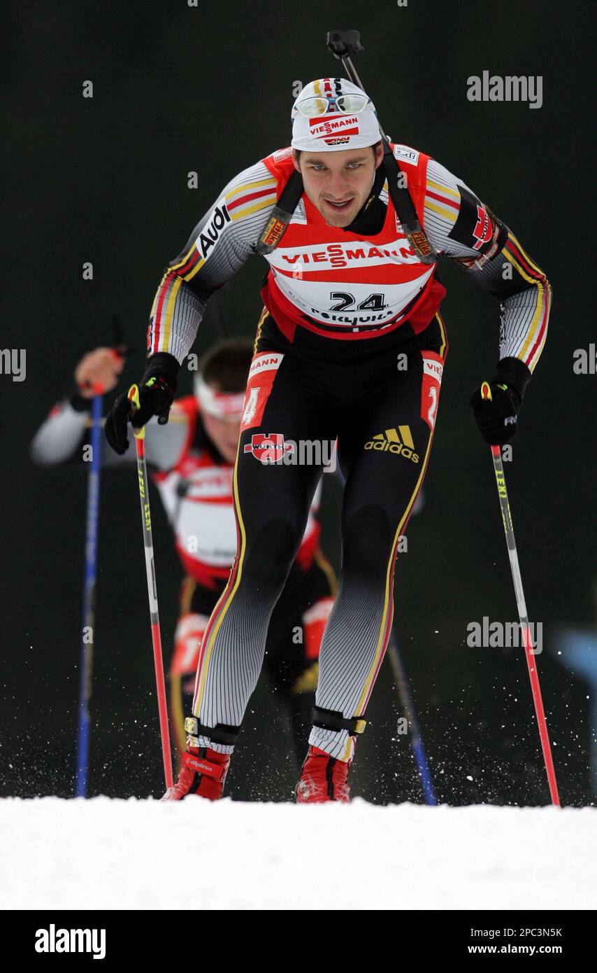 Alexander Wolf from Germany skis in front of Sven Fischer, also from  Germany, to win a 10 km men's sprint sprint race at the World Cup biathlon  event in Pokljuka, Slovenia, Thursday,