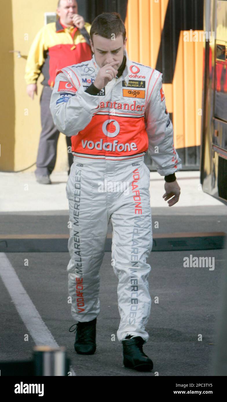 Reigning Formula One World Champion and Vodafone McLaren Mercedes driver  Fernando Alonso, from Spain, walks towards the paddock after having  problems with his new MP4-22 racing car during a training session at