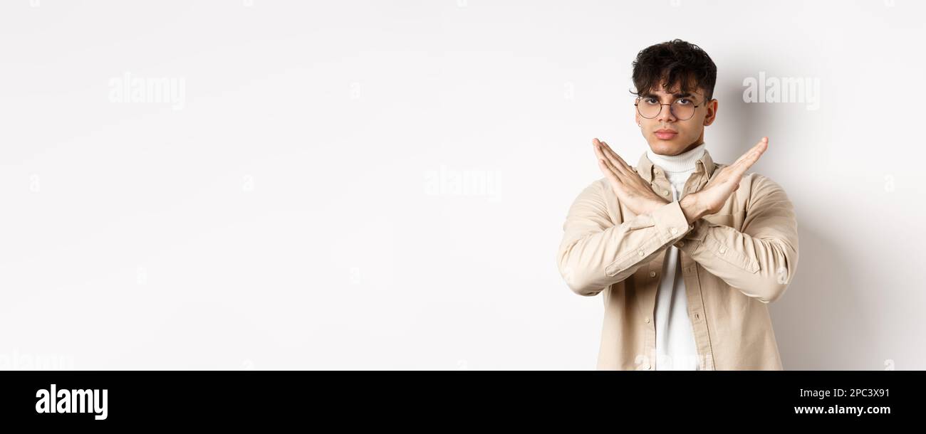 Man Disagree Sign Image of serious young guy in glasses say no, showing cross gesture ...