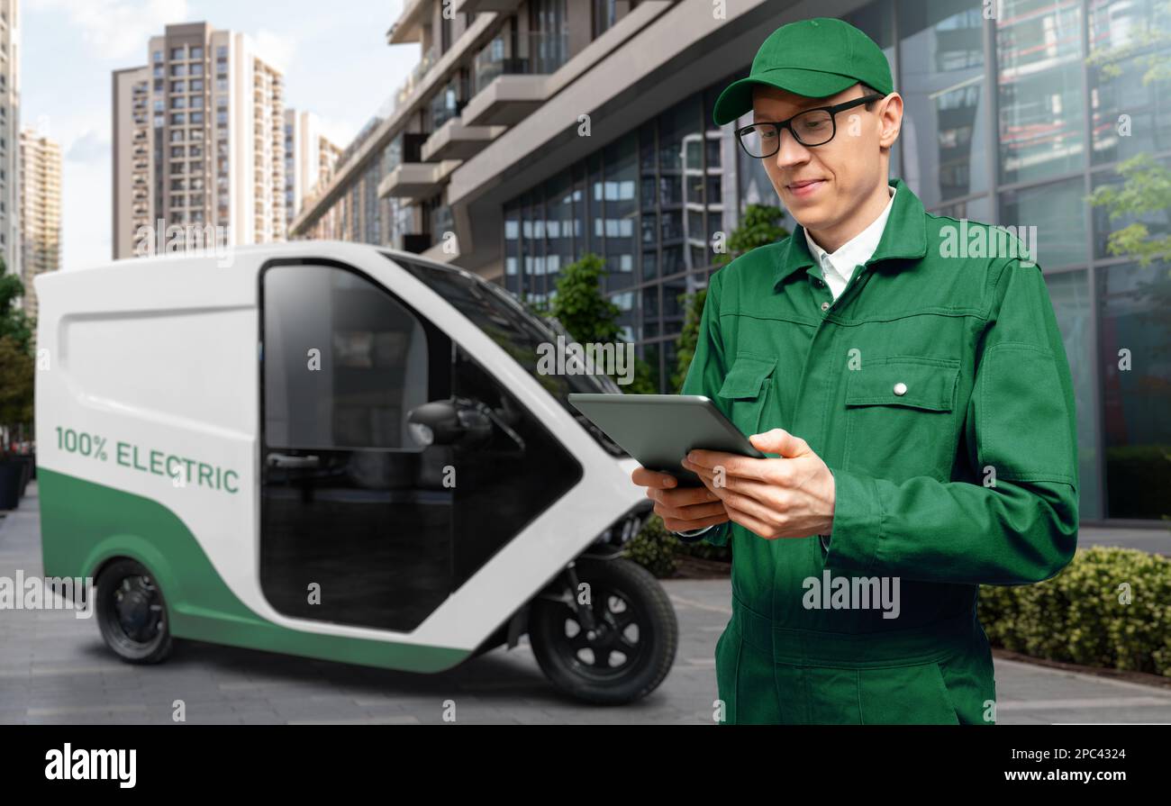 Delivery man with digital tablet on a background of electric scooter Stock Photo
