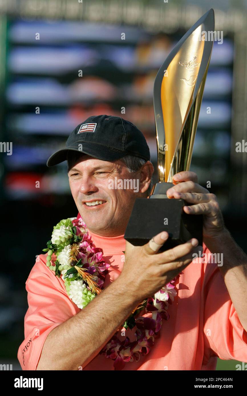 Paul Goydos, of Dove Canyon, Calif., holds up his trophy on the 18th