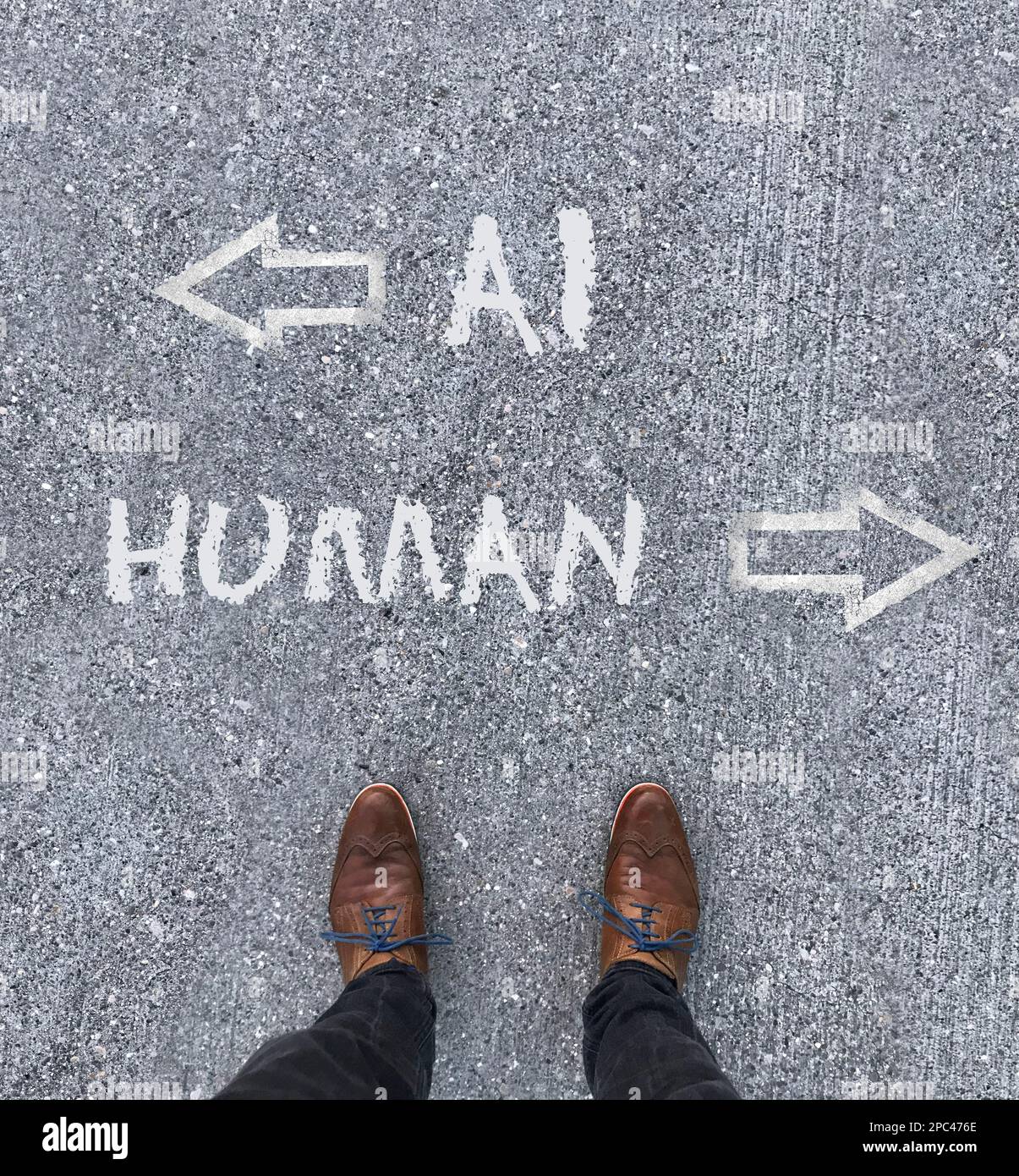 Man looking down at the words Artificial Intelligence - AI - and Human chalked onto the floor Stock Photo