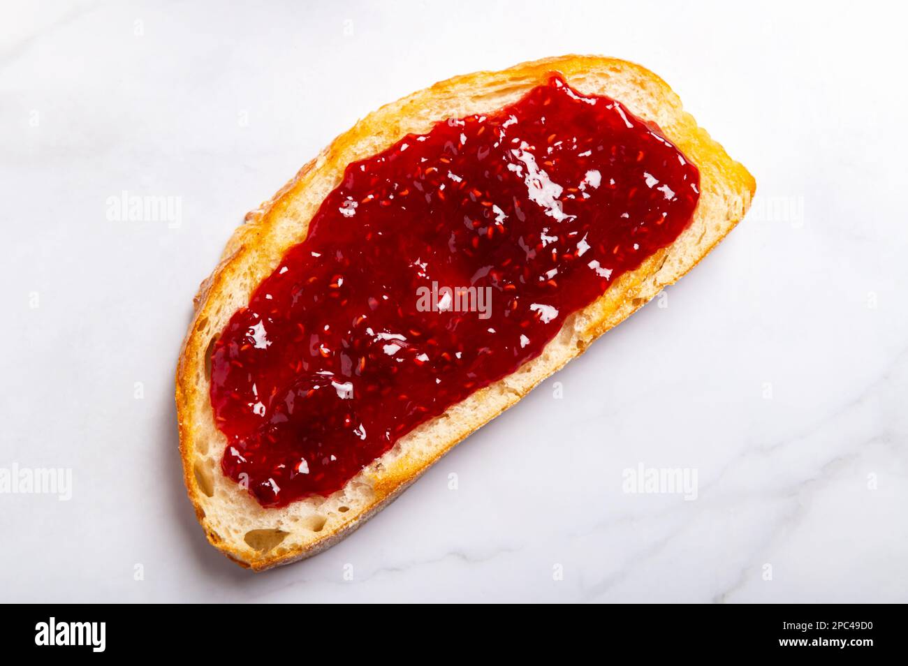 Raspberry jam on toast Stock Photo Alamy