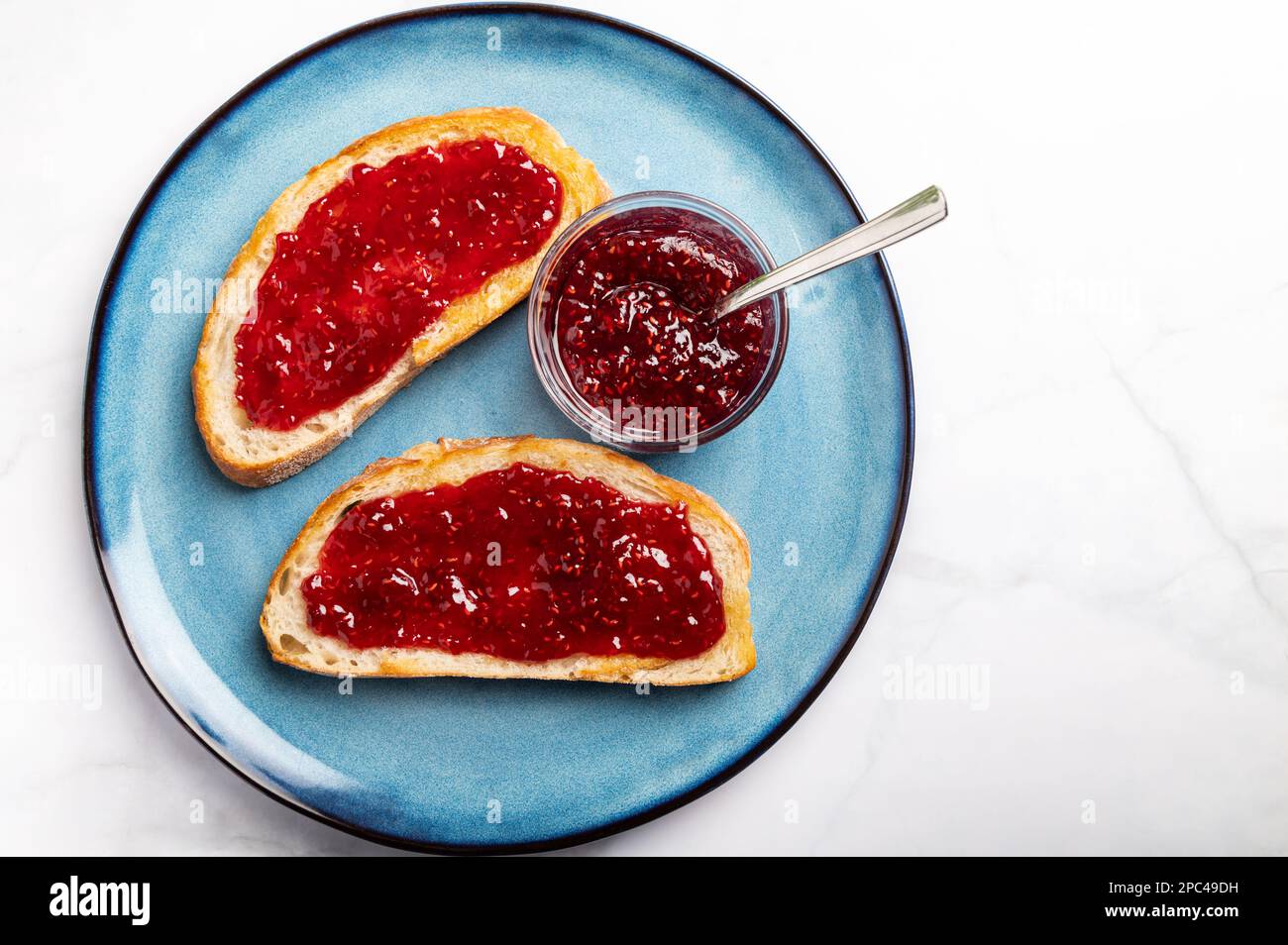Raspberry jam on toast Stock Photo Alamy