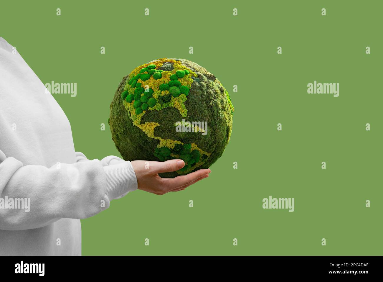 Woman holds a green planet Earth. Symbol of sustainable development and renewable energy Stock Photo