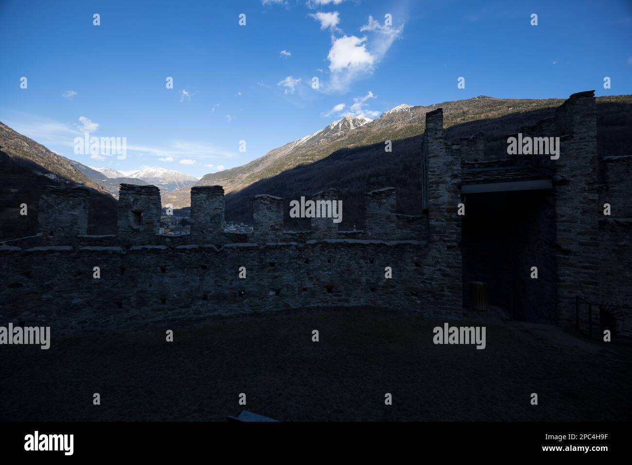 Valtellina, Italy - March 12, 2023: street view of the ancient walls surrounding Old Castle in Grosio, a fort in ruins. No people are visible. Stock Photo