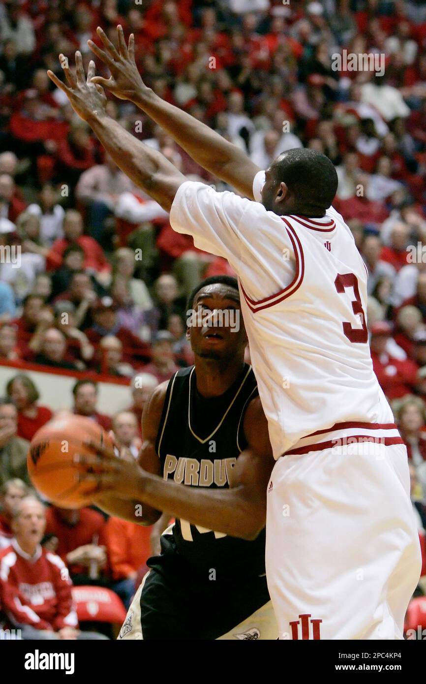 Purdue forward Carl Landry, left, is defended by Indiana forward D.J ...