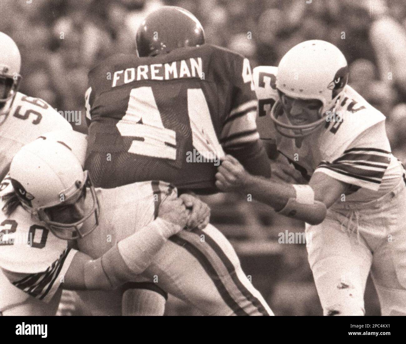 Minnesota Vikings running back Chuck Foreman (44) gets a heck of a tackle  from San Francisco 49ers free safety Ralph McGill after making a seven-yard  gain in the first half of their NFL game in Bloomington, Minn., Dec. 4,  1977. The Vikings made a