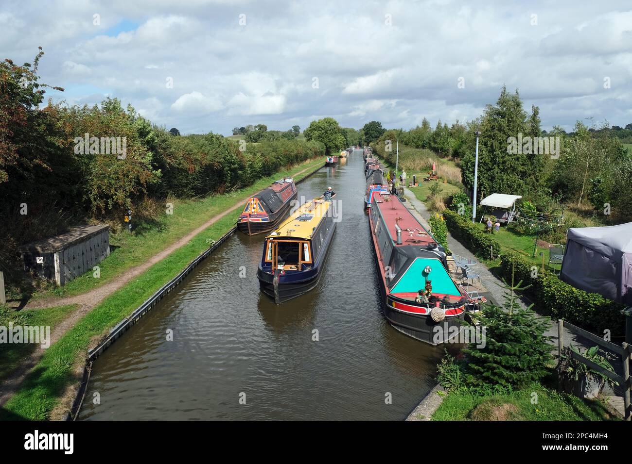 A narrow boat approaching Norbury Junction, Shropshire Union Canal, England. Stock Photo