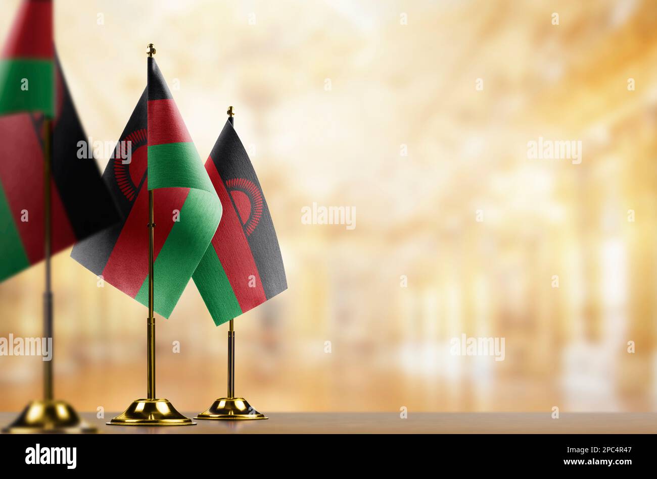 Small flags of the Malawi on an abstract blurry background Stock Photo ...