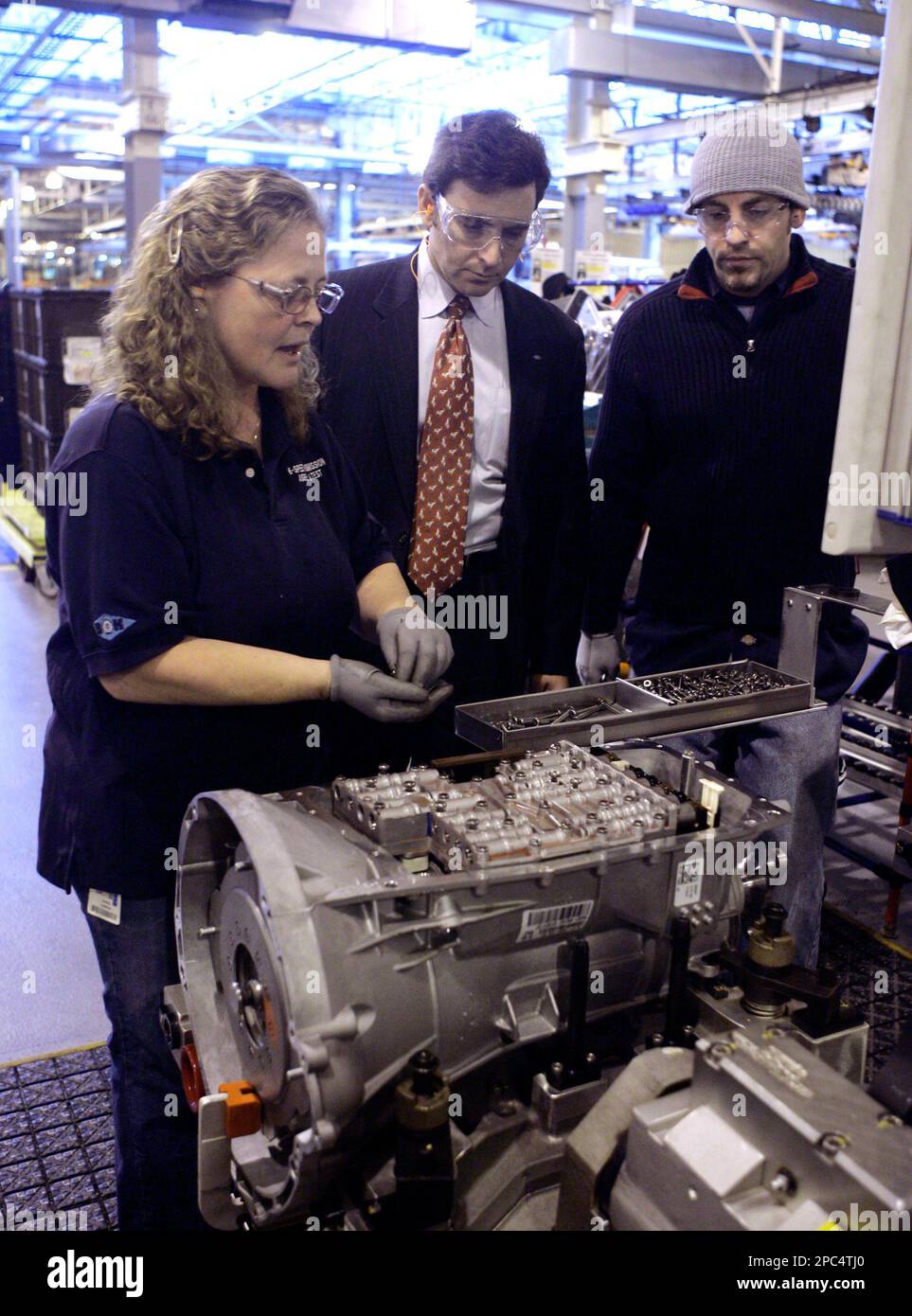 Mark Fields, Ford executive vice president and president of the Americas  looks over the transmission main control installation with assemblymen Barb  Sabon, left, and Mike Chaves at the Livonia Transmission Plant in
