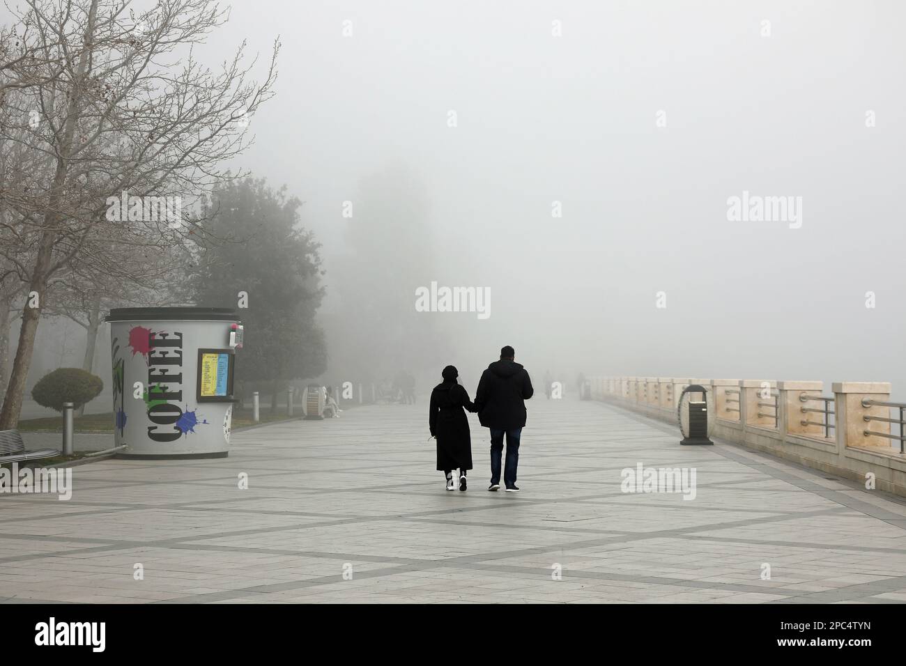 Walkers at Baku Boulevard on a foggy winter day Stock Photo