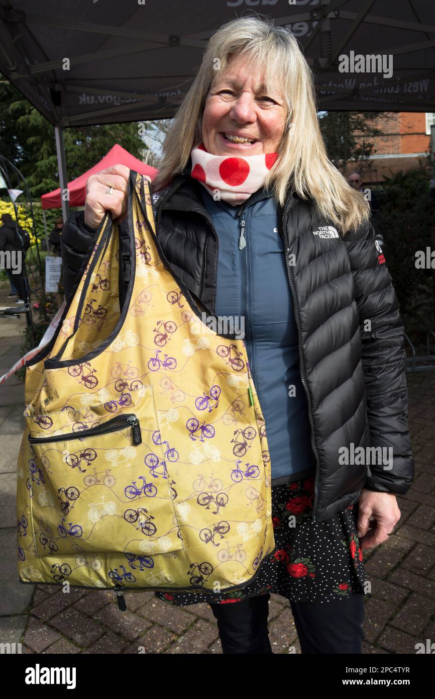 female cycling enthusiast displays a bag decorated with cycle images at the 2023 kew ecofair, southwest london, england Stock Photo