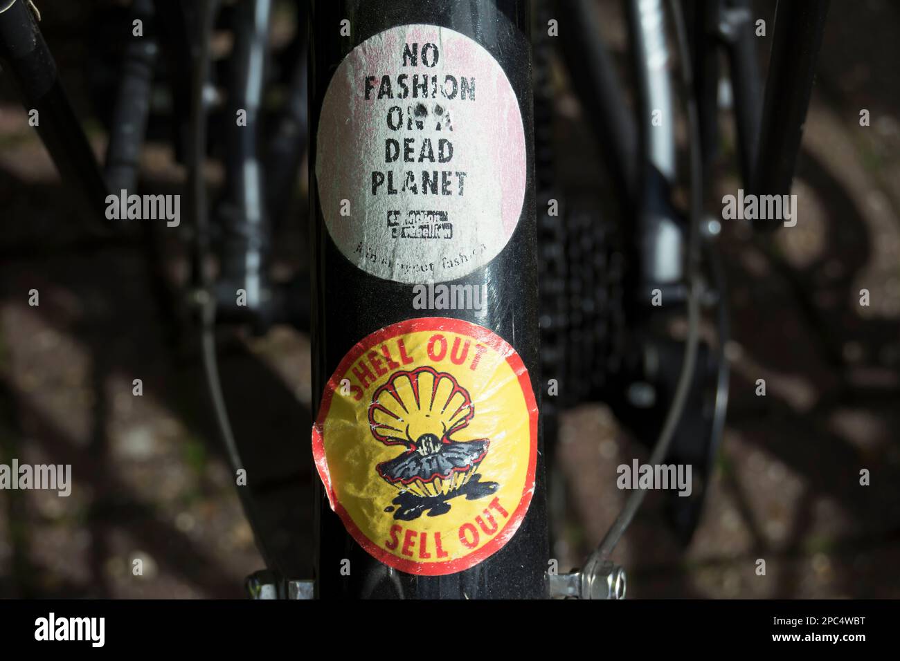 environment and climate change related stickers on a parked bicycle  including those of extinction rebellion and opposing fossil fuel Stock Photo