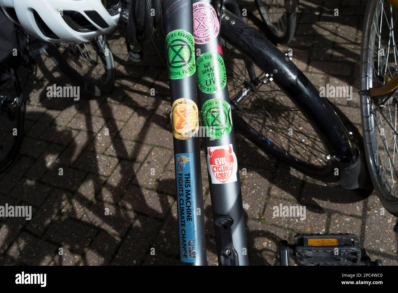 environment and climate change related stickers on a parked bicycle  including those for extinction rebellion and pedal on parliament Stock Photo